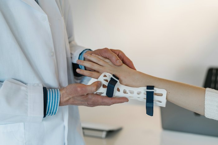 A doctor fitting a wrist brace
