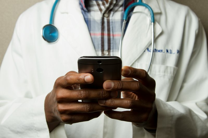A doctor reading a message on a phone