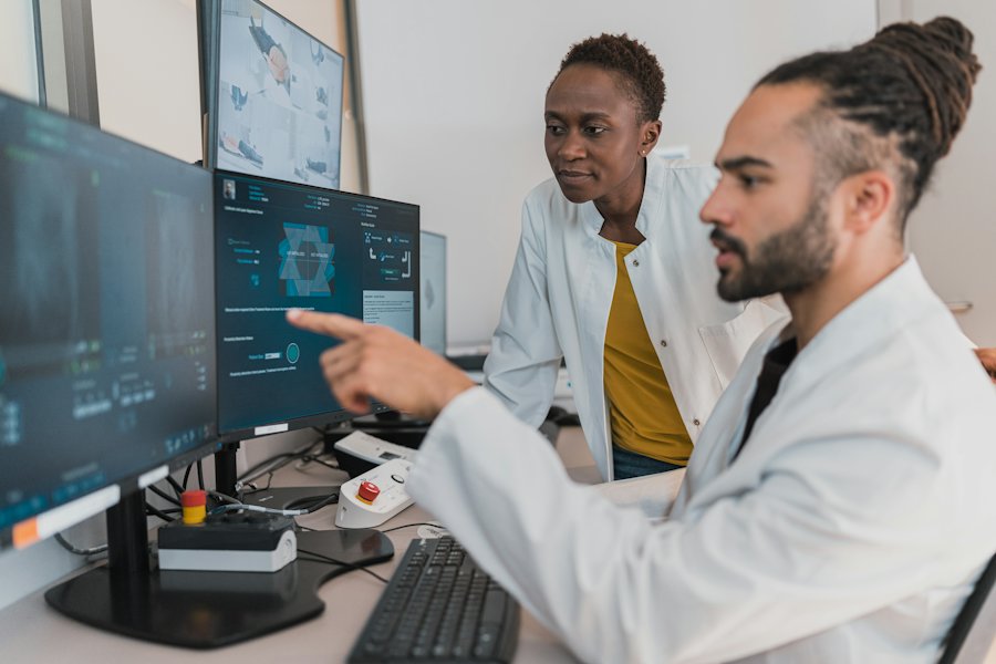 Two doctors pointing at a scan on a screen